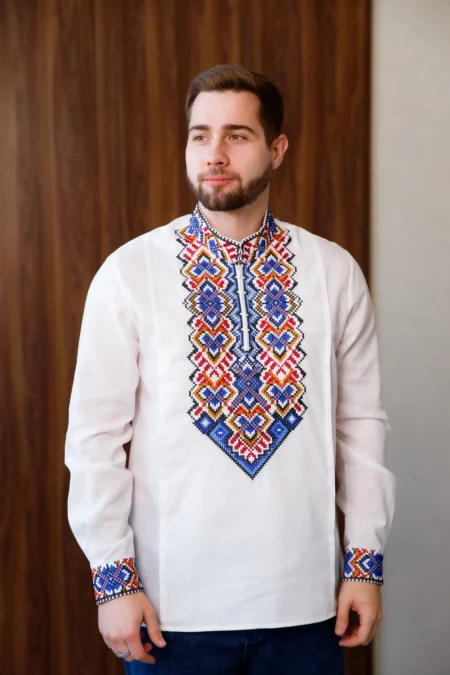 Вишитий орнамент у синьо-червоних відтінках на білій чоловічій сорочці